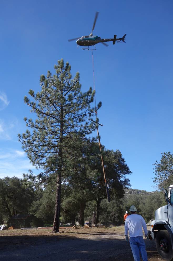 A helicopter setting a power pole in Ramona
